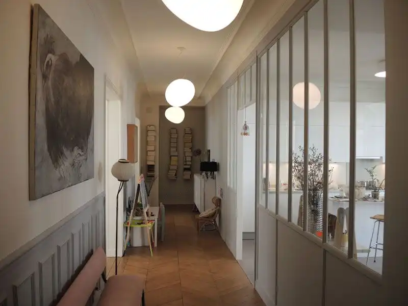 Verrière d'atelier séparant un espace sans perte de luminosité dans un appartement rénové.
